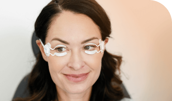 Patient wearing TearCare SmartLids during treatment